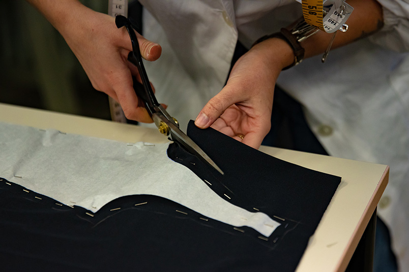 Craftsmen cutting their fabric